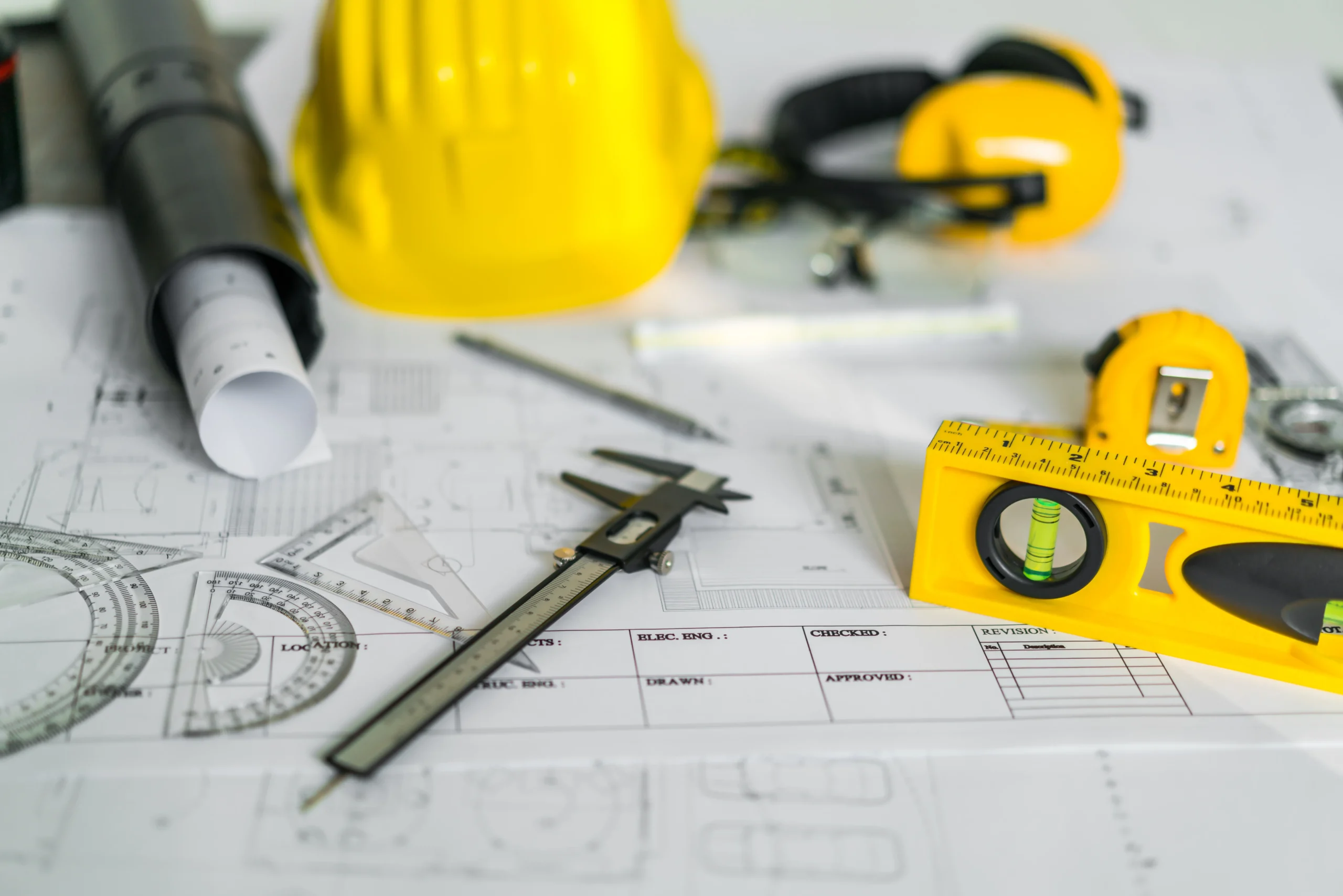 construction-plans-with-helmet-drawing-tools-blueprints-scaled
